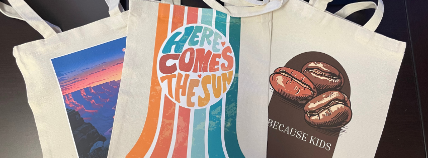 Three canvas tote bags customized with print-and-cut heat transfer vinyl.