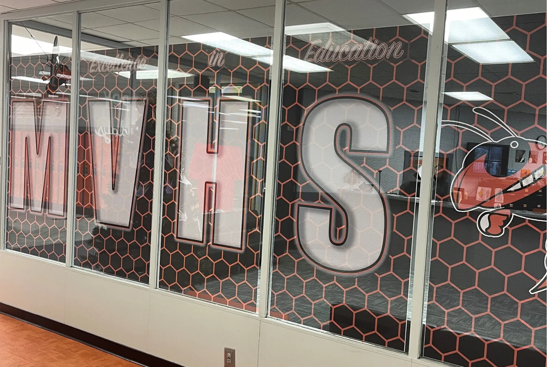 Perforated window graphics in a high school hallway