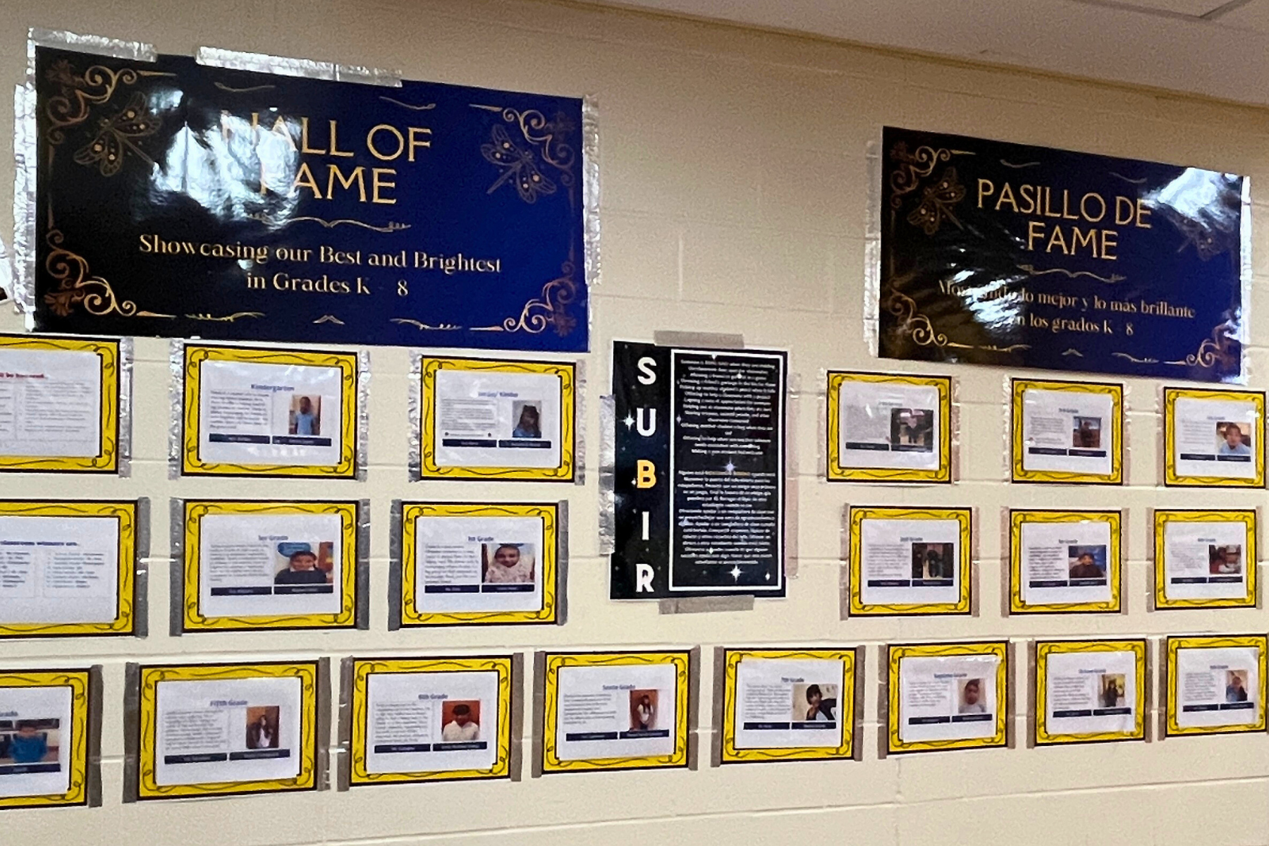 Bilingual student wall of fame in a school hallway