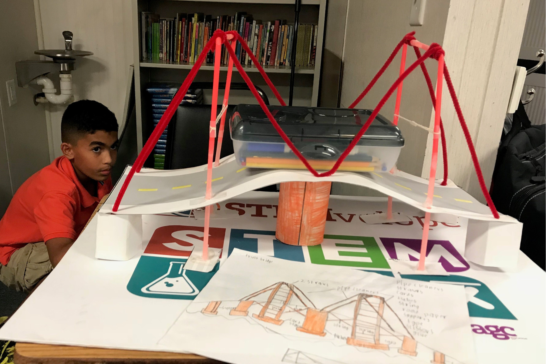 A student building a bridge with STEMvelope lessons and Educator Plus